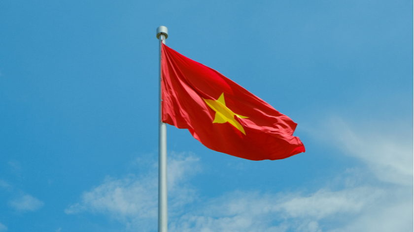 Vietnamese flag flying against a blue sky