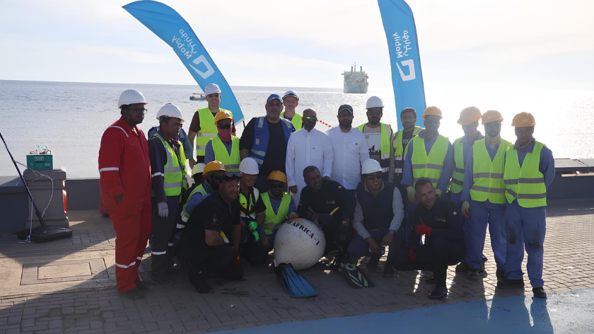 Mobily staff celebrate the successful landing of the Africa-1 cable in Duba, Saudi Arabia