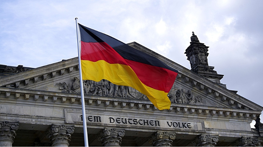 German flag flying outside of the Reichstag Building in Berlin, Germany