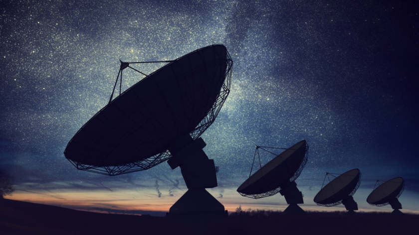 Silhouettes of satellite dishes/space observatory/radio antennas against the night sky