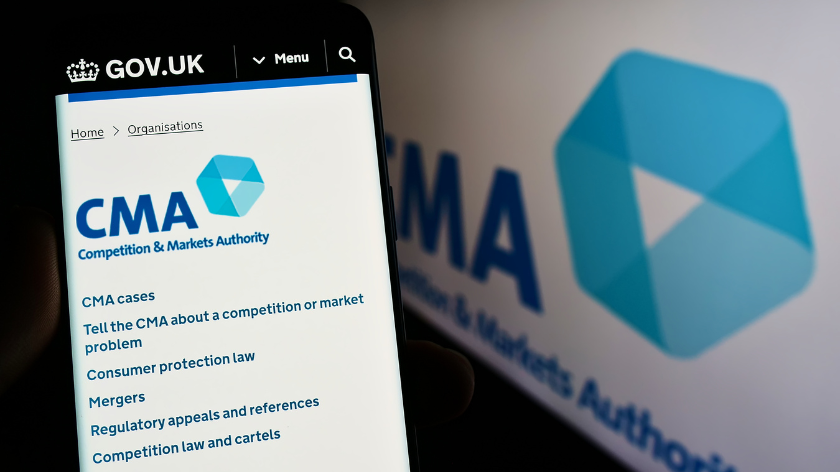 Person holding mobile phone with website of British Competition and Markets Authority (CMA) on screen with logo