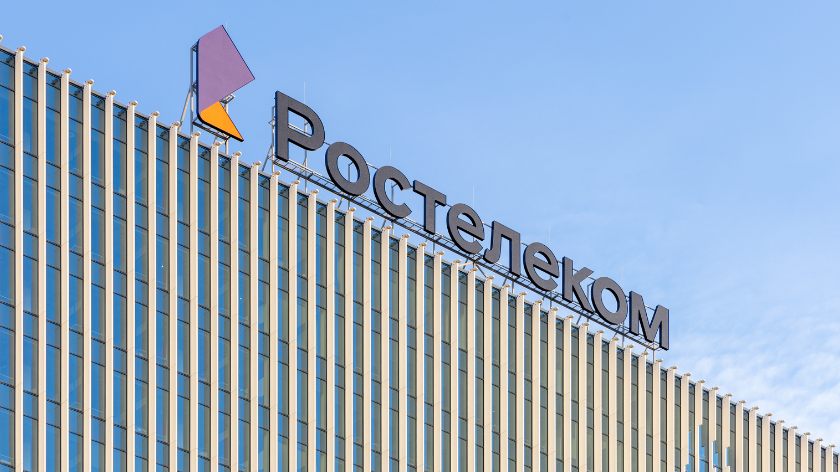 Close-up of signboard Rostelecom at the top of the building. 