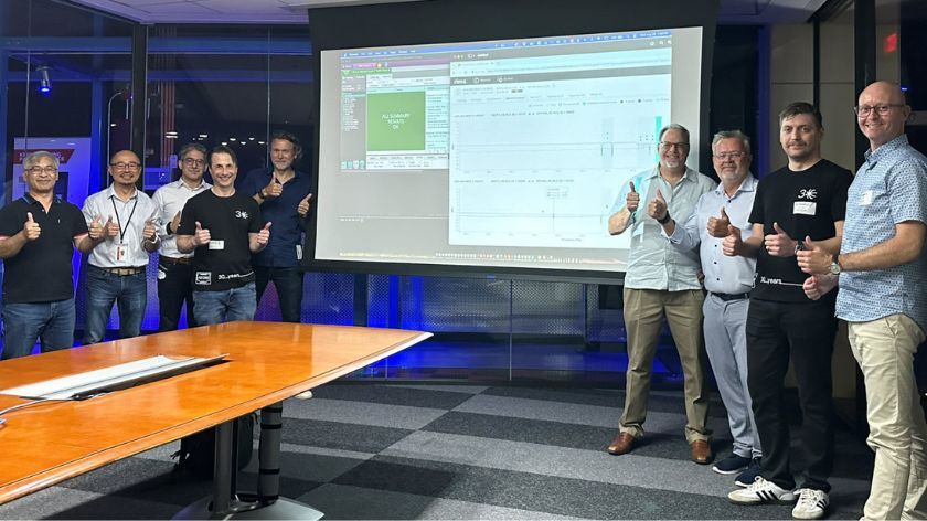 A group of people standing in front of a whiteboard with their thumbs up