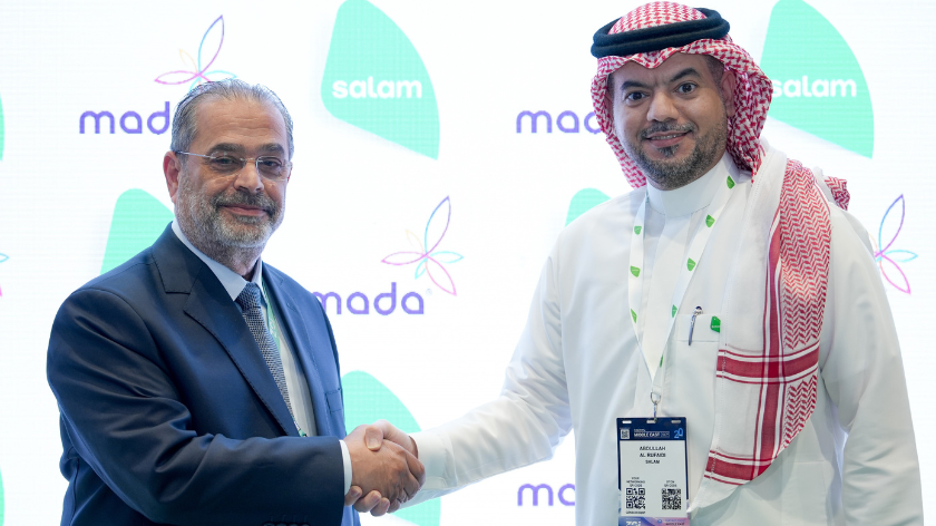 From left: Adel Louis, VP of carrier relations and business development at Mada shakes hands with Abdullah Alrufaidi, wholesale sales director at Salam